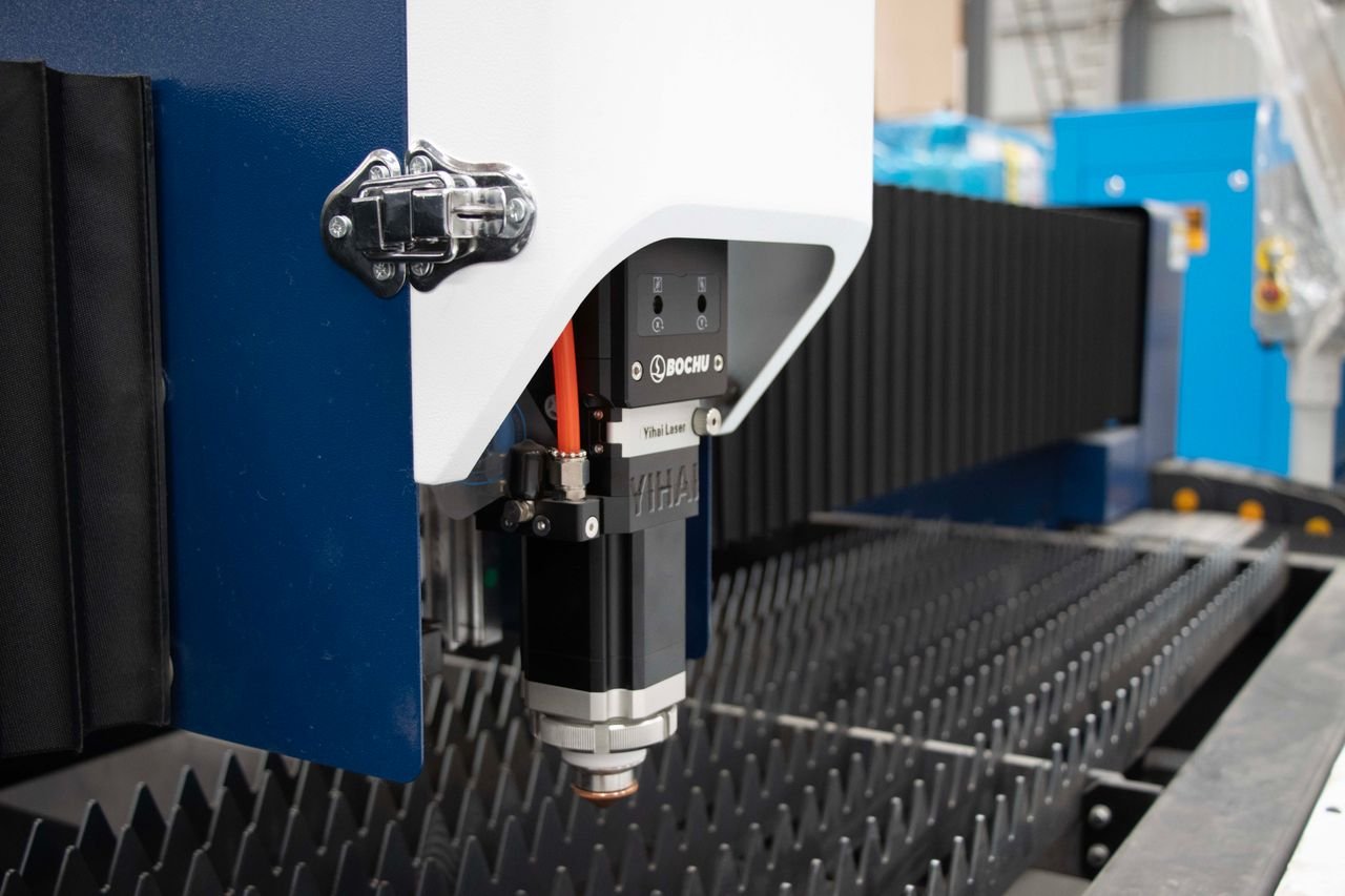 Detailed view of a precision industrial laser cutter in a manufacturing environment.